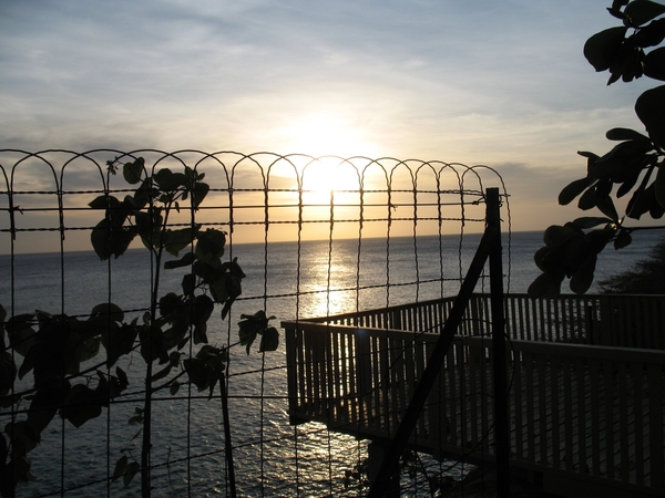 zonsondergang door het hek