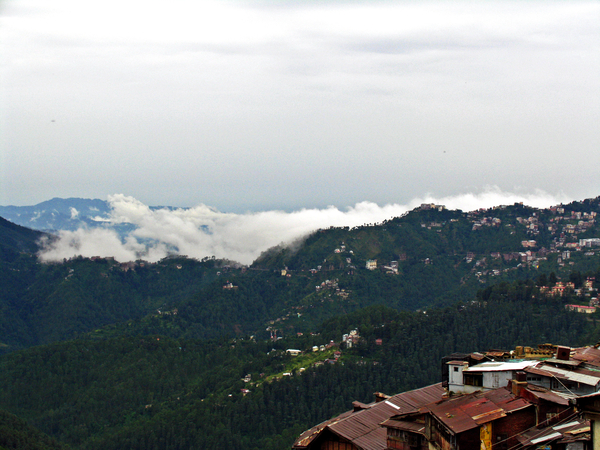 LAAGHANGENDE WOLKEN TUSSEN DE HEUVELS IN SHIMLA