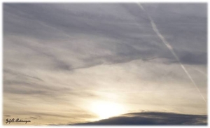 Zon zakt bij valavond achter de wolken. Kattendijkdok Oostkaai