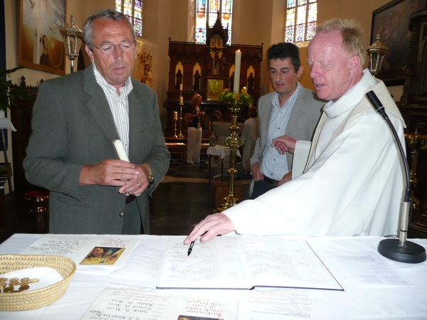 Peter Marc tekent het doopboek.