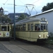 Twee trams bij het Haarlemmermeerstation. EMA wagens HTM 824 (nu 