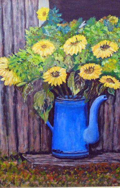 zonnebloemen in koffiekan
