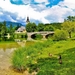 Slovenia-bridge-river-church-grass-summer-clouds_1680x1050