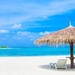 Maldives-indian-Ocean-Sun-loungers-and-palm-trees-straw-umbrella-