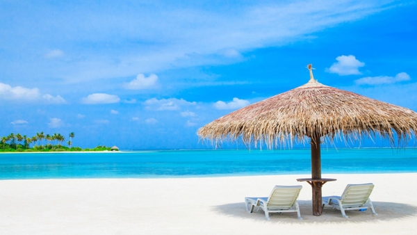 Maldives-indian-Ocean-Sun-loungers-and-palm-trees-straw-umbrella-