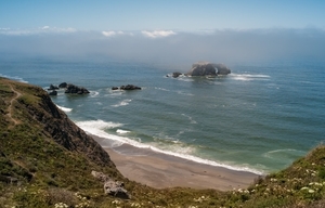 fog_rolling_over_arched_rock